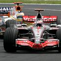 McLaren Formula One driver Alonso of Spain is chased by Renault driver Fisichella of Italy during the French F1 Grand Prix in Magny Cours